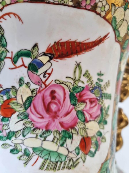 Hand-painted panel depicting a colorful pheasant bird and pink roses on a Chinese export porcelain vase
