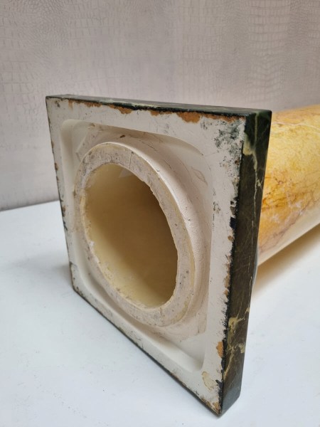 Close-up of the deep green marbled base on a decorative interior pillar stand