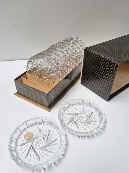 Set of vintage mid-century Bohemian crystal coasters in a black and gold box