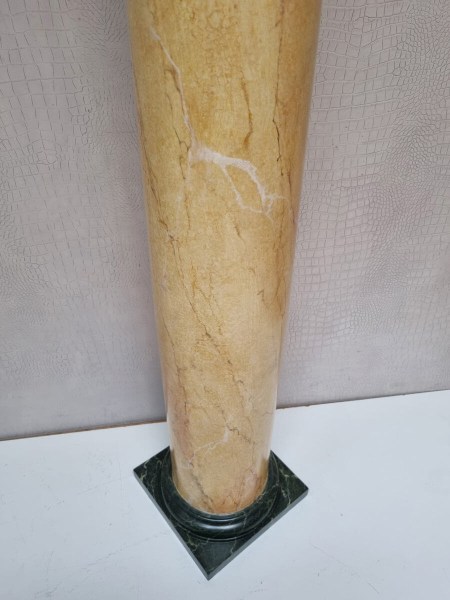 Close-up of the deep green marbled base on a decorative interior pillar stand